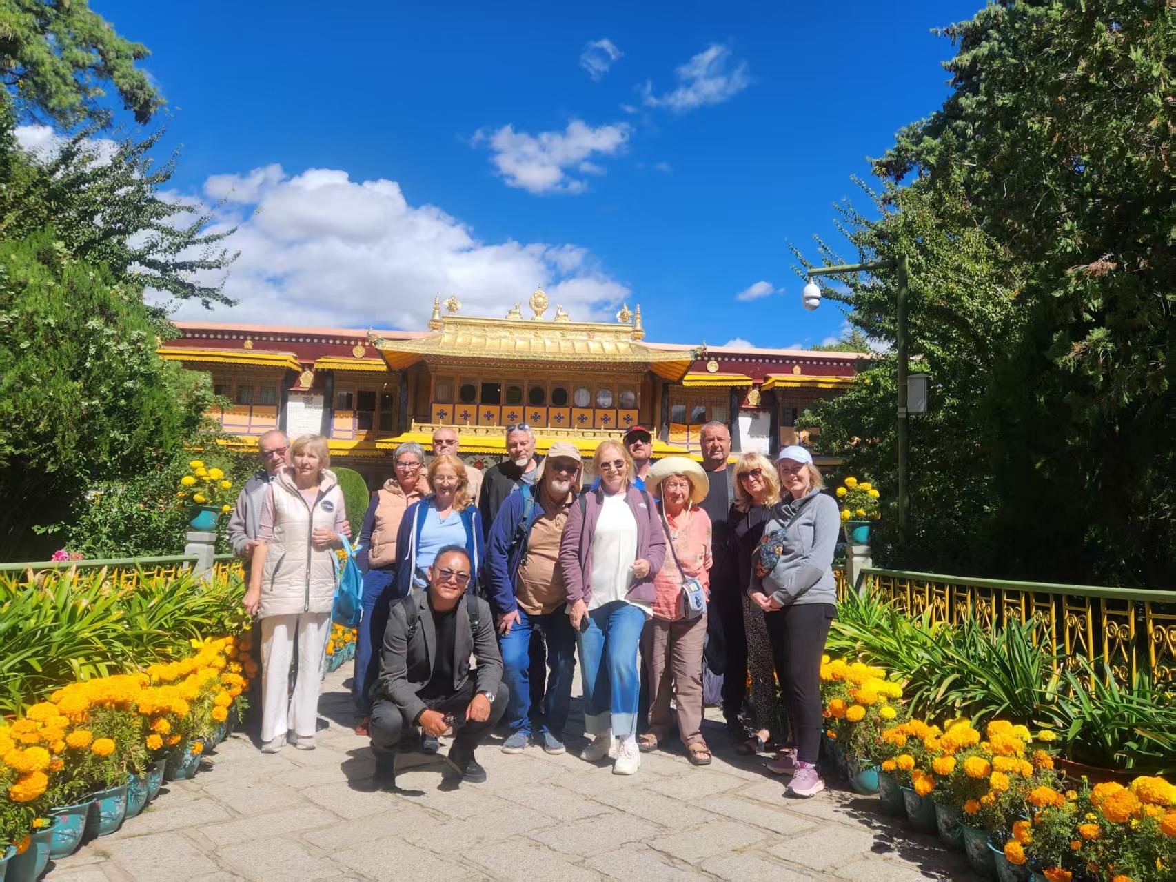 Group standing in a beautiful temple garden